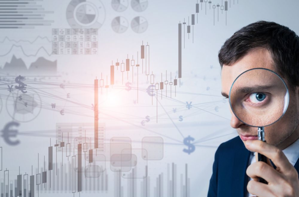 Man With Magnifying Glass And Graphs