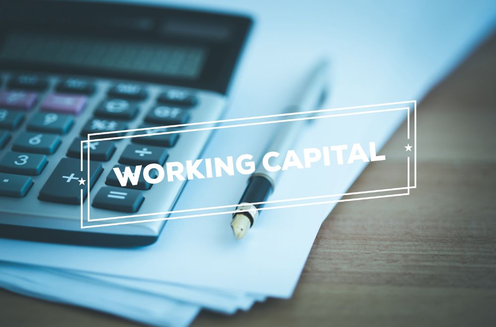 Desk And Calculator With Words Working Capital Written