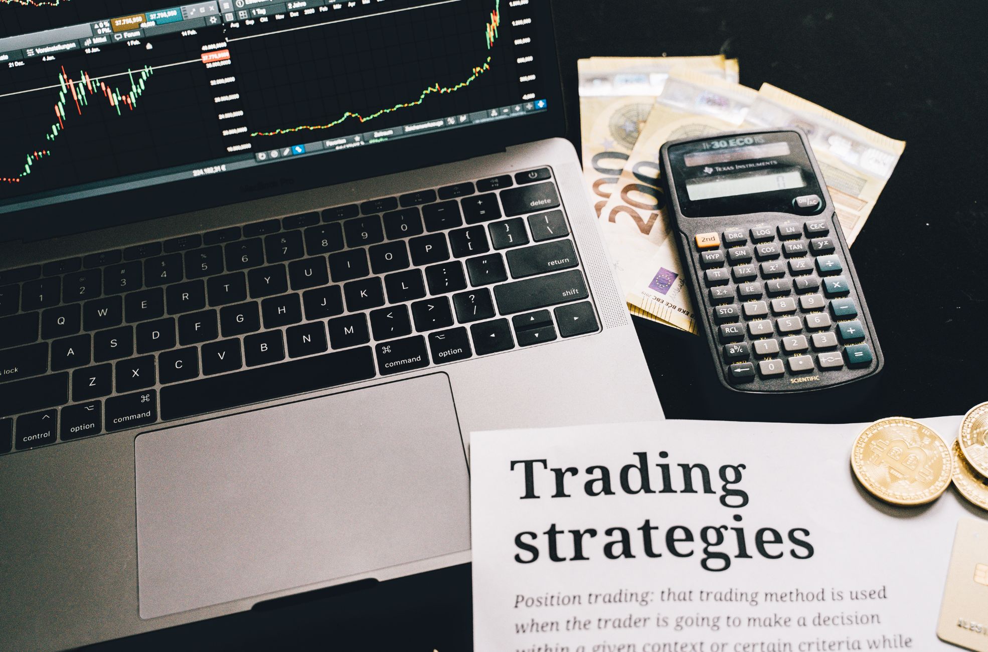 Trade Strategies List Next To MacBook And Calculator