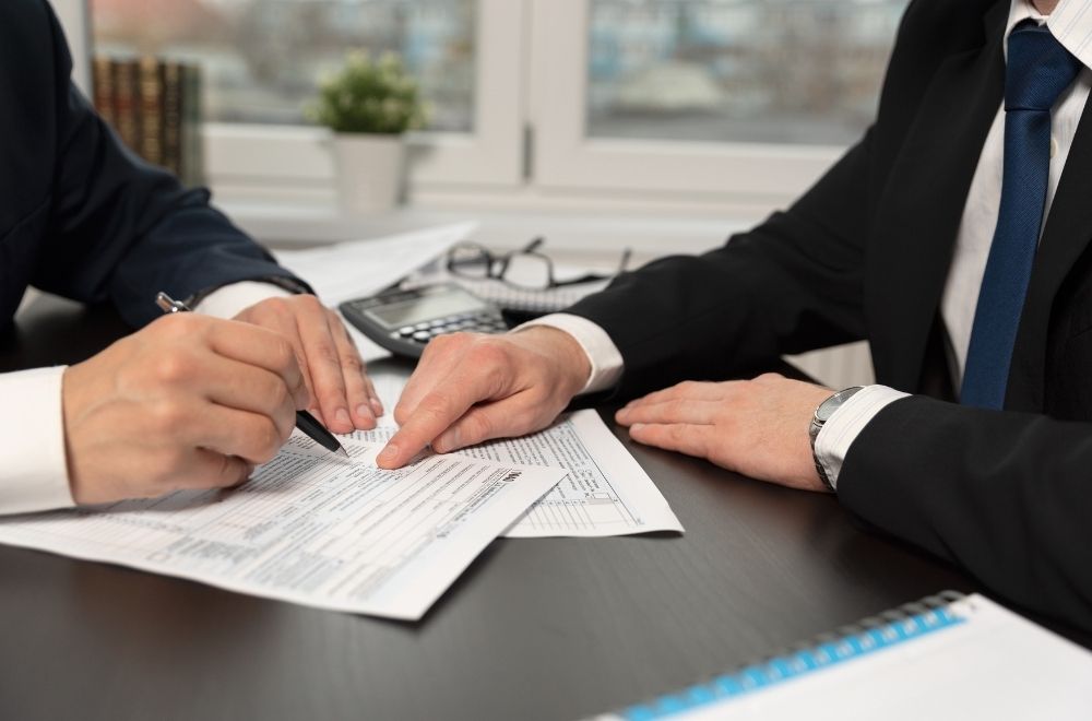 Men Doing Taxes At Desk