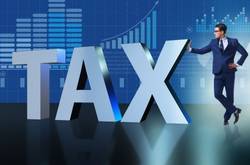Businessman And Tax Sign