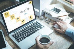 Person Working On Brand Awareness On Laptop
