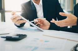 People Working on Financing At A Desk