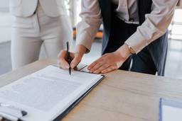 Person signing a No Objection Certificate document for a UAE business or employment process.