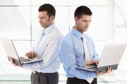 Two Men Working On Laptops