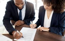 Business partners reviewing documents for a free zone company.