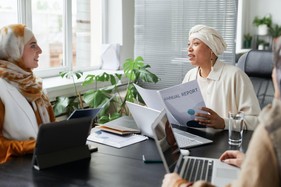 Free Women in a Business Meeting Using A General Trading Licence Stock Photo