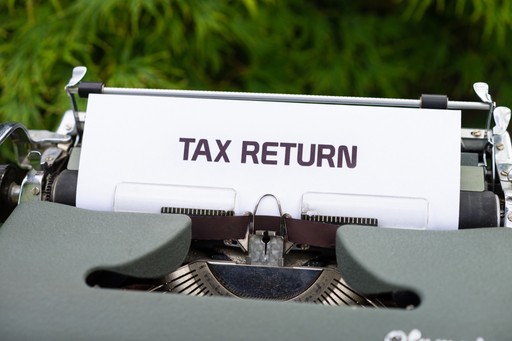 stock photo of typewriter saying tax return on paper