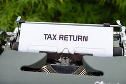 stock photo of typewriter saying tax return on paper