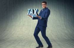 Man Holding Tax Sign