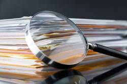 Document Pile And Magnifying Glass