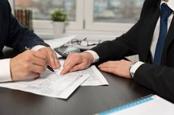Men Doing Taxes At Desk