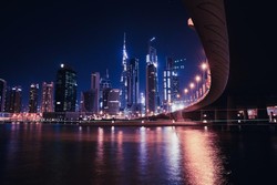 Cityscape photo of high-rise building during nighttime in Dubai business district