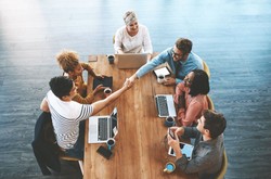 Employee And Manager Shaking Hands During Meeting