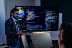 IT consultant presenting network, cloud and cybersecurity solutions to a business team.