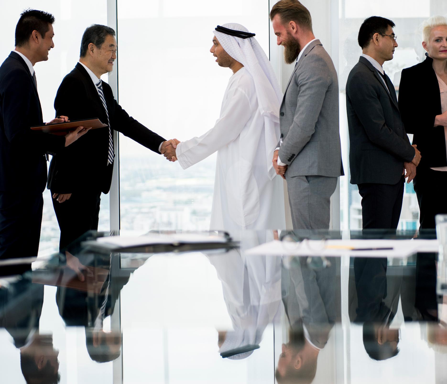 International business partners forming a joint venture in Dubai.